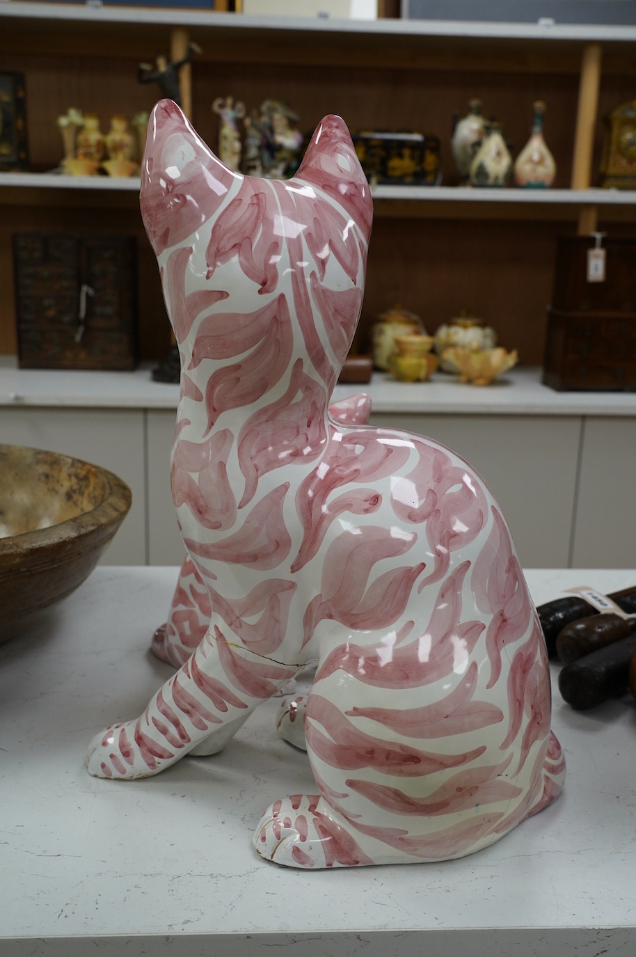 A large 1950's Italian pink maiolica seated cat and two smaller, largest 45cm. Condition - poor